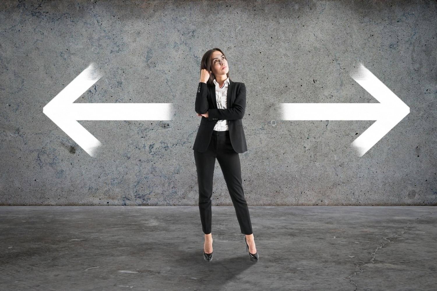 Businesswoman weighing two directions, representing supply chain risk decisions in the UAE